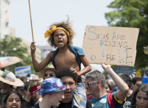 Photo shows Levi marching with other youth platintiffs in the 2017 People's Climate March in D.C. Photo Credit: Robin Loznak/Our Children's Trust
