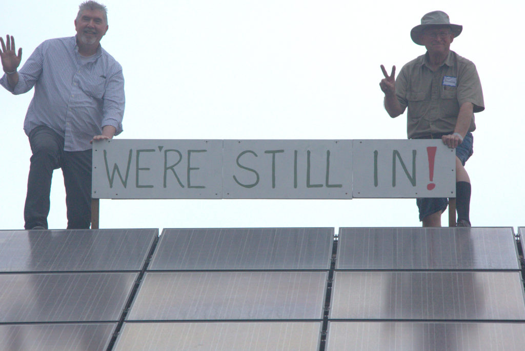 Unitarian Church of Lincoln Nebraska Green Sanctuary Committee Members boldly show their 96 Rooftop Solar Panels, (John Riley, Curt Donaldson), also members of Lincoln’s Environmental Task Force for We Are Still In (Photographer Linda R. Brown)